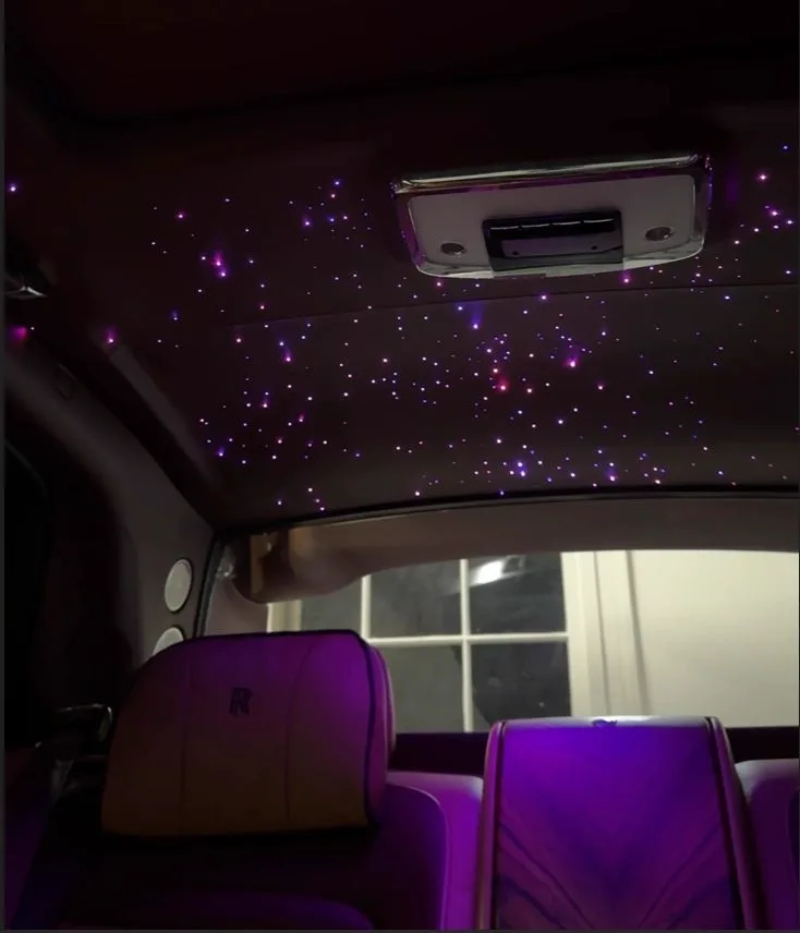 Starlight headliner glowing purple inside a Rolls-Royce Cullinan